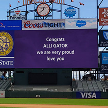 A scoreboard message at Oracle Park wishing Alli Gator good luck